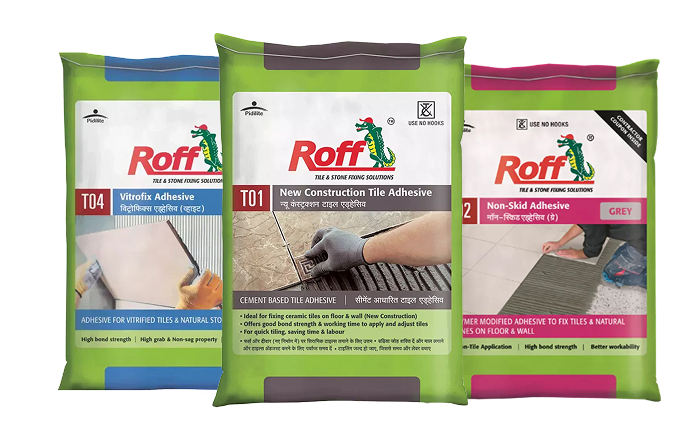 Roff tile adhesive product range showing T01, T02, T03, T09, and T20 bags with tile spacers and professionally tiled bathroom wall for reference