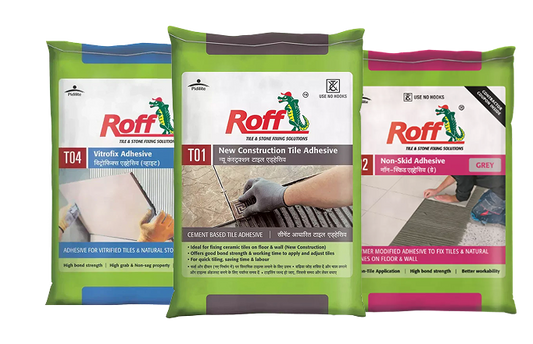 Roff tile adhesive product range showing T01, T02, T03, T09, and T20 bags with tile spacers and professionally tiled bathroom wall for reference